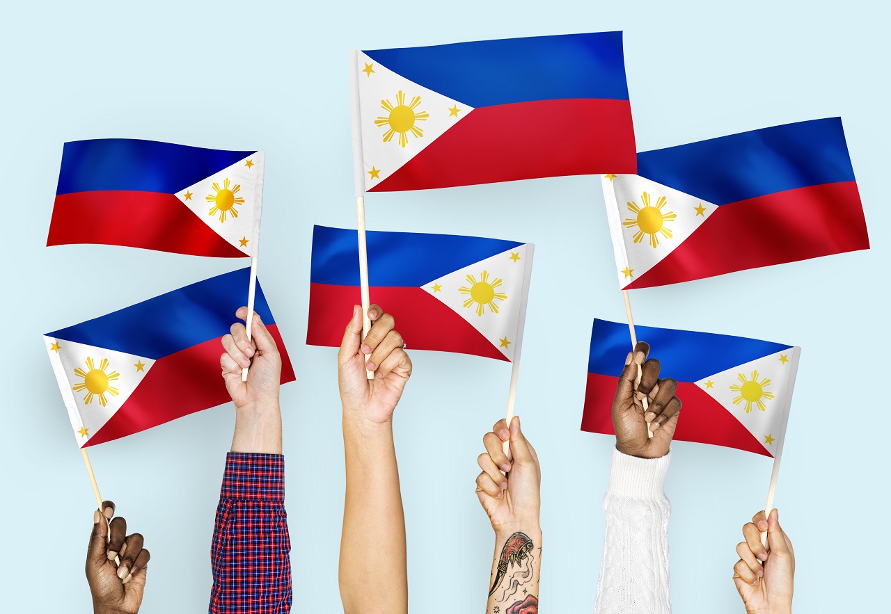 Hands waving Philippine flags