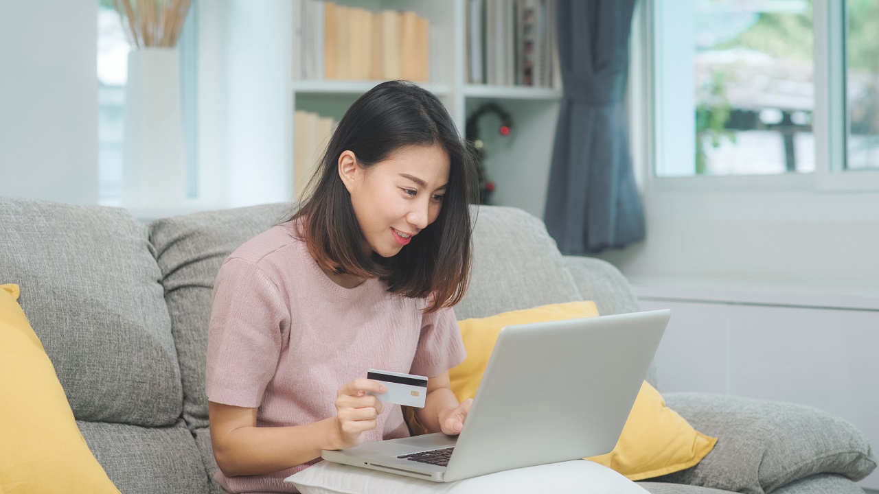 A young woman paying her loan payments online