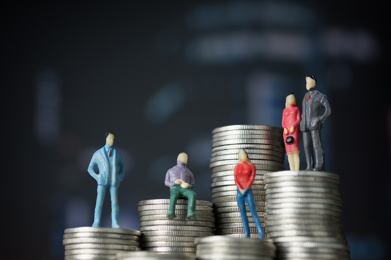 Miniature figurines of co-borrowers on stacks of coins
