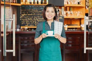A Filipina at the front door of her small coffeeshop