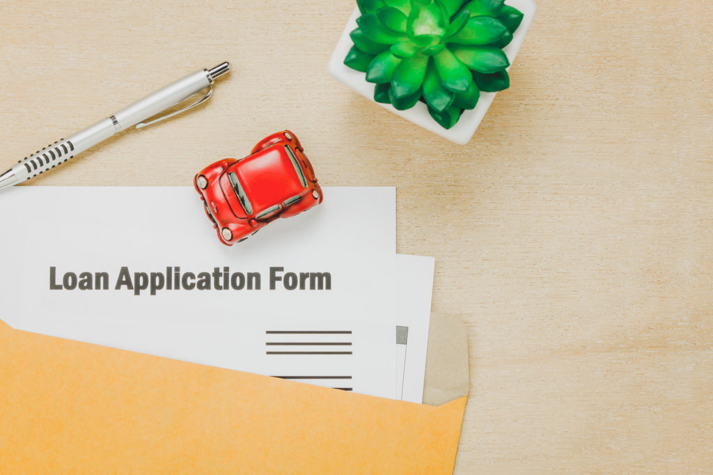 Loan application form with red toy car