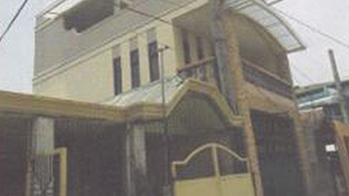 A photo of house with yellow gate