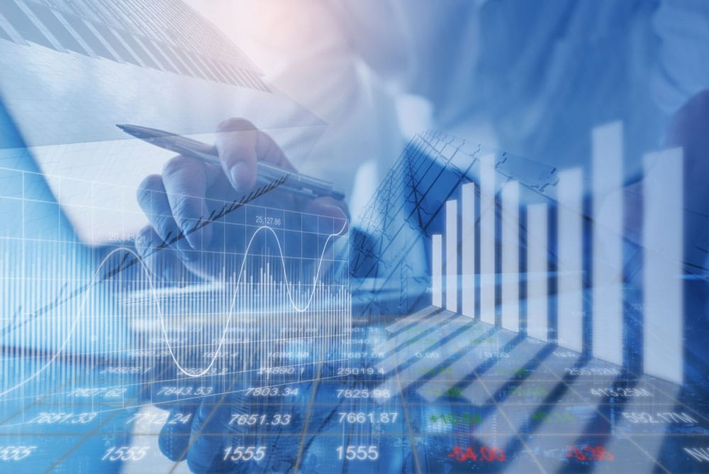 Blue double exposure of businessman and stock market or forex graph. Economy trends are in the background.