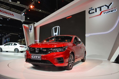 A red Honda City at a car exhibit. This is to illustrate the article's discussion of cars with the best resale value.
