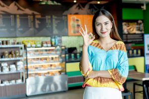 Woman smiling and giving the A-OK sign